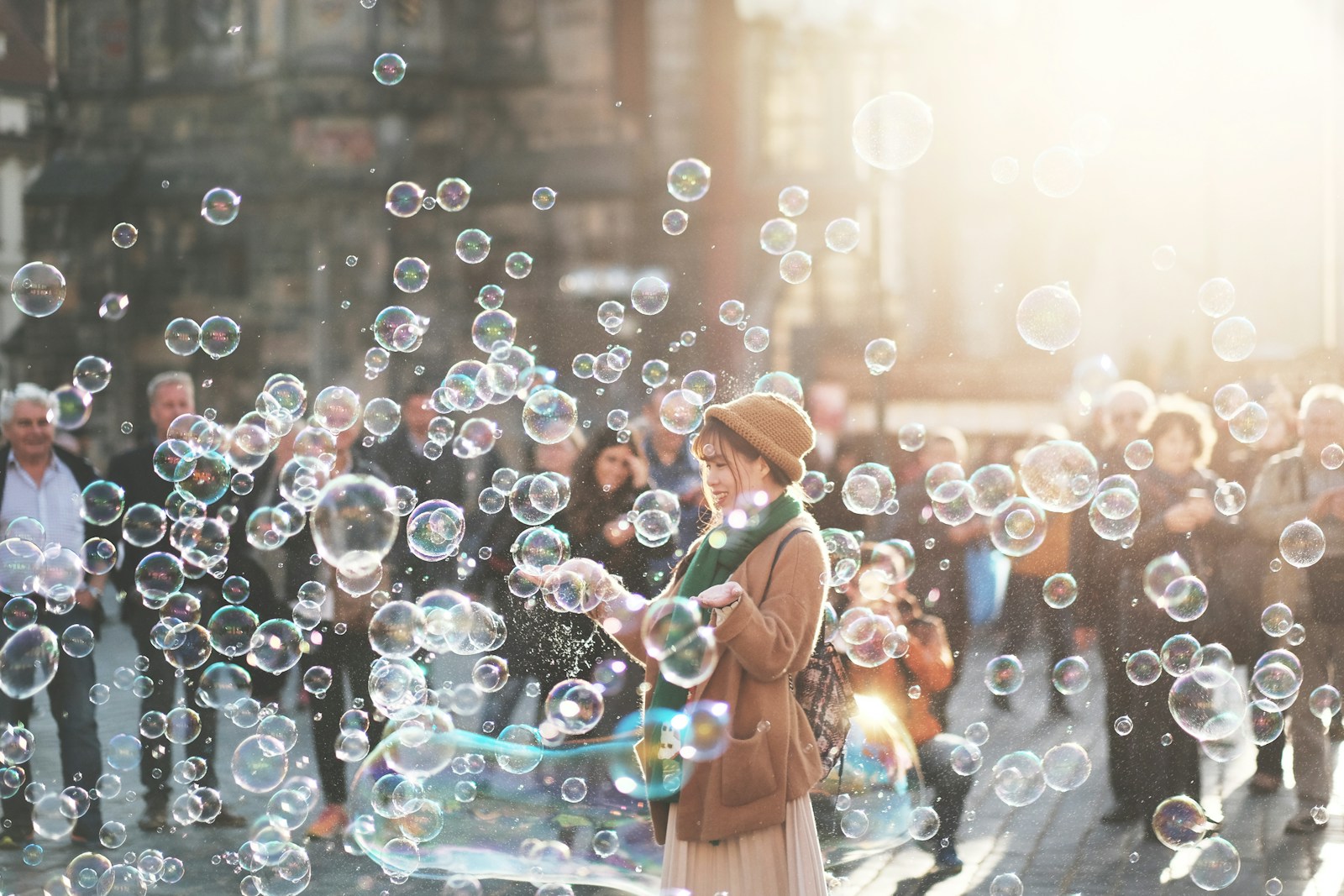 Photo by Alex Alvarez woman standing outdoor surrounded by bobbles during daytime